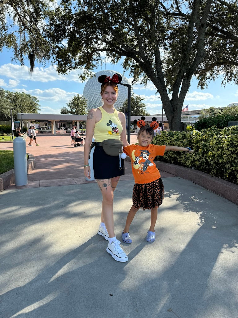 amber & nova stand outside of Epcot's Food & Wine Festival